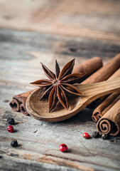 Close-up, star anise and cinnamon sticks on a wooden background, macro shot.