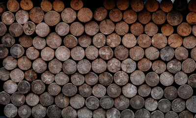 Wall of stacked wood logs.