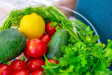 Vegetables on a white plate. Tomatoes and avocados.