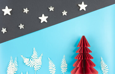 Obraz premium Christmas background with origami paper tree on paper background, flat lay.