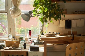 Background image of rustic crafting workshop in cozy home studio lit by sunlight and decorated with...