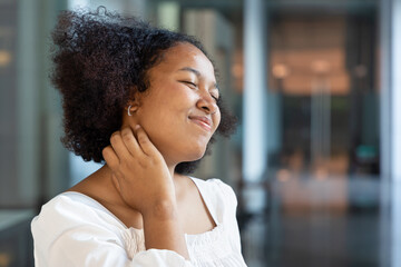 Happy African woman scratching her neck skin, concept of dry skin, allergic dermis inflammation,...