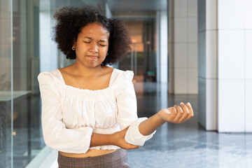 African woman suffering from tennis elbow syndrome, pain from elbow injury