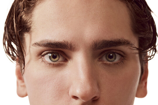 Close-up image of male green eyes of young man isolated over white background. Concept of vision, healthcare, medicine, men's beauty