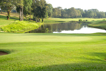 The beauty of golf courses, green grass and ponds.