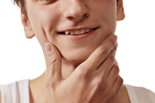 Cropped image of male face, mouth and teeth over white background. Dental care. Concept of male beauty, body and skincare