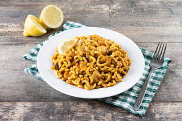 Traditional Spanish fideua on wooden table. Noodle paella 