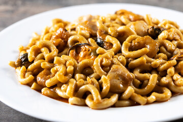 Traditional Spanish fideua. Noodle paella on wooden table