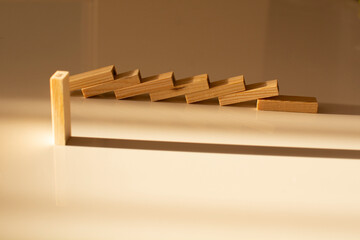 shadows from wooden blocks on a beige background. Abstract. The concept of sustainability and leadership