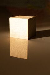 A wooden cube and its reflection. Business and design concept, Symbol of leadership