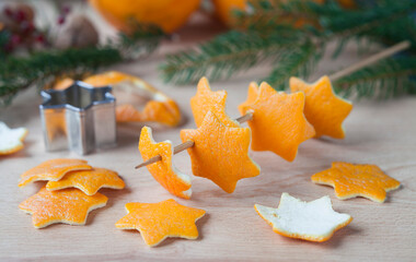 Zero waste handmade Christmas decor  - a craft made by cutting in star shape the scrap orange peel. Once they dry can be used as ornaments to decorate a Christmas tree.