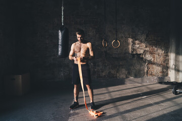 Strong man standing with hand wrap in gym