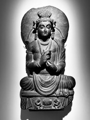 Vertical shot of a shakyamuni buddha sculpture isolated on a white background