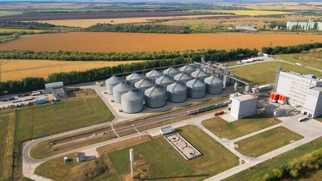 Wide angle closing shot of agro silos granary elevator on agro-processing manufacturing plant. Aerial