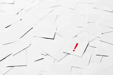 Pile of blank pieces of paper with red exclamation mark in the middle