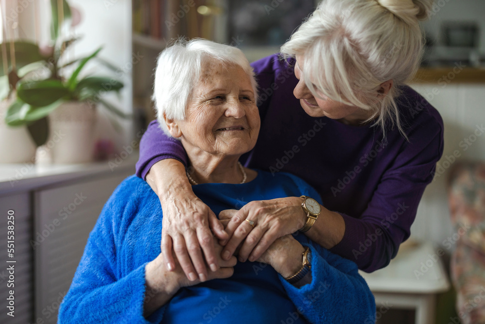 Poster woman hugging her elderly mother