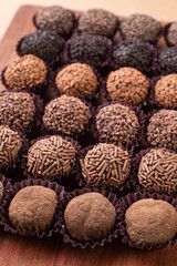 Typical brazilian brigadeiros, various flavors over wooden table