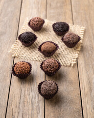 Typical brazilian brigadeiros, various flavors over wooden table