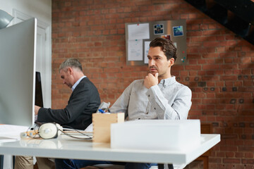 Young businessman, office employee at desk and man thinking of strategy, business solution and...