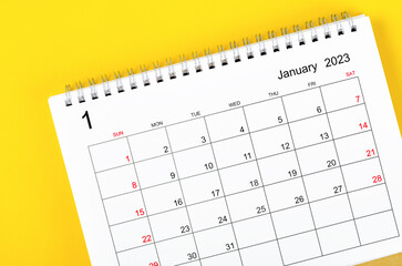 Close up the January 2023 Monthly desk calendar for 2023 year on yellow background.