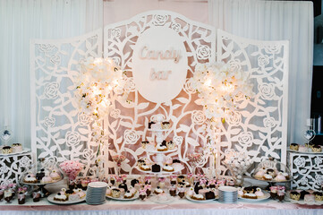 Candy bar. Table with sweets, candies, dessert. Delicious reception. Celebration concept.