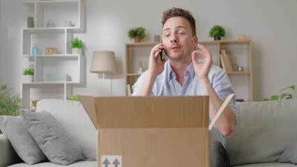 Man sit on sofa with parcel talks on smartphone thanks friend via phonecall for received gift, prepare parcel for sending negotiates to courier, e-commerce retail services satisfied client concept