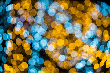 Image of blurred bokeh background with warm colorful lights. Abstract bokeh night light