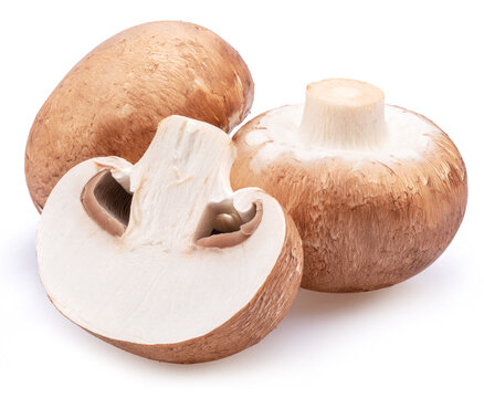 Brown cap champignons with slice of champignon mushroom isolated on white background. Close-up.