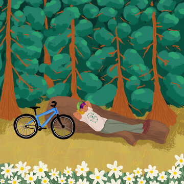 Bicyclist resting on log in forest