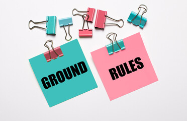 Colorful stickers with GROUND RULES text and multicolored paper clips on a white background