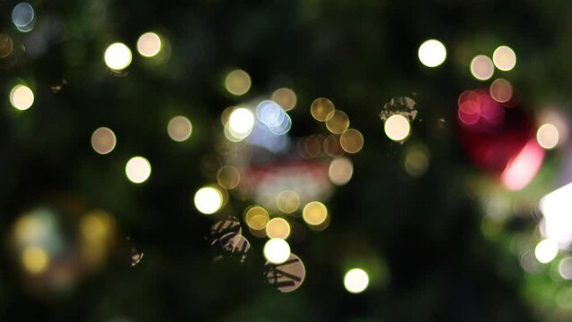 Christmas tree blurred with lights and ornaments A blurry silhouette of a cozy Christmas tree. Happy New Year 2023.