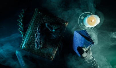 Mystical book of magic and tarot cards for divination on a dark table. Panoramic mockup for your...