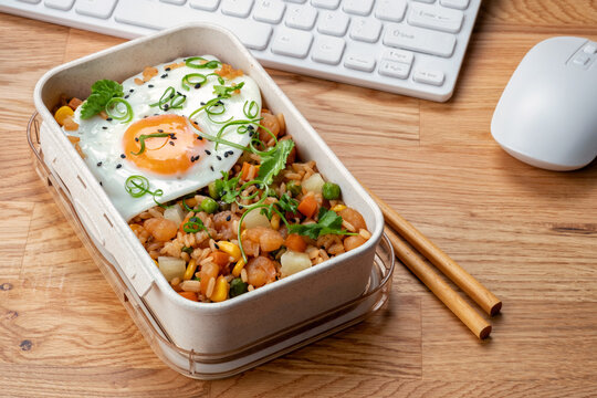 Shrimp Fried Rice With Vegetables And Fried Egg In A Lunch Box