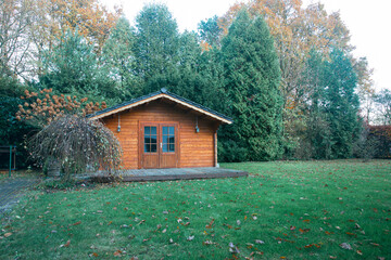Beautiful forest hut for holidays in the forest. Garden shed with yellow leaves and trees in late...