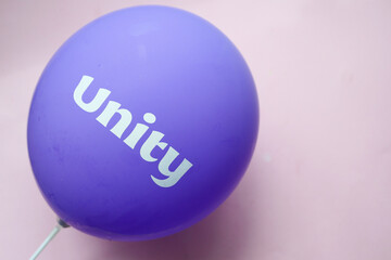 unity text on a purple color ballon,