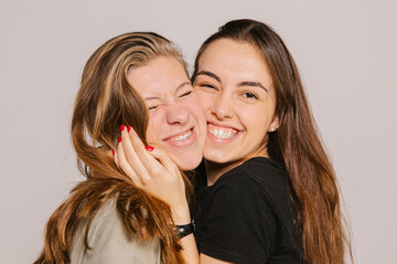 Smiling teens kissing and looking at camera