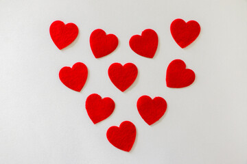 10 Valentine’s day red cotton hearts in a heart shape. Love, valentine’s day, celebration concept.