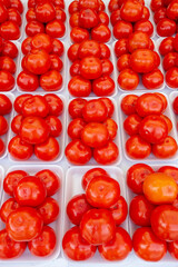 Stacks of persimmon symmetrically organized to sale on street market. Sao Paulo city, Brazil