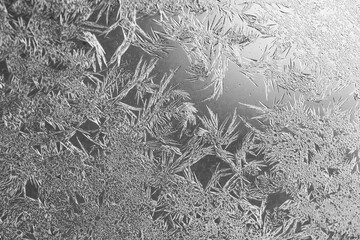 Frozen texture. Frost patterns on frozen window as a symbol of Christmas wonder.