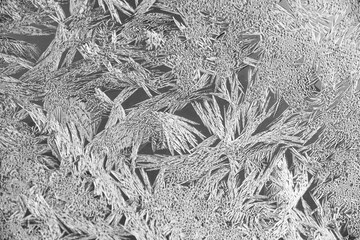 Texture of ice on the glass, icy surface of a frozen window, background, blue monochrome.