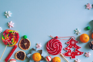 Christmas or New Year composition with candy cane, fir branch and tangerines