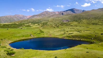 panoramic view of a small mountain lake. a beautiful lake in the mountains. summer mountains. green mountain hills