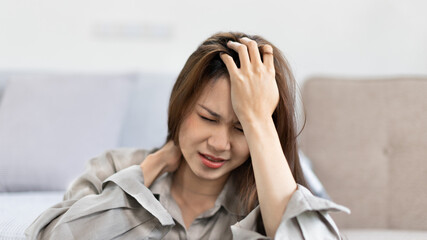 Stressed woman holding her temples with severe problems in her life, Family problems, Pressure from work, Poor financial, Despair in life, discouraged and deeply saddened, Panic attacks.