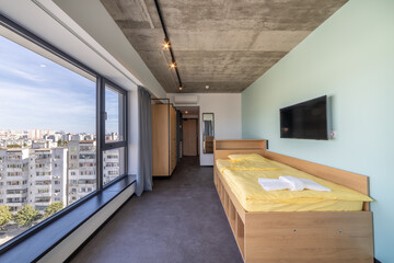 Simple student-style dorm bedroom. Hostel dormitory room. Campus