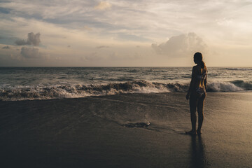 Silhouette of woman on sandy beach