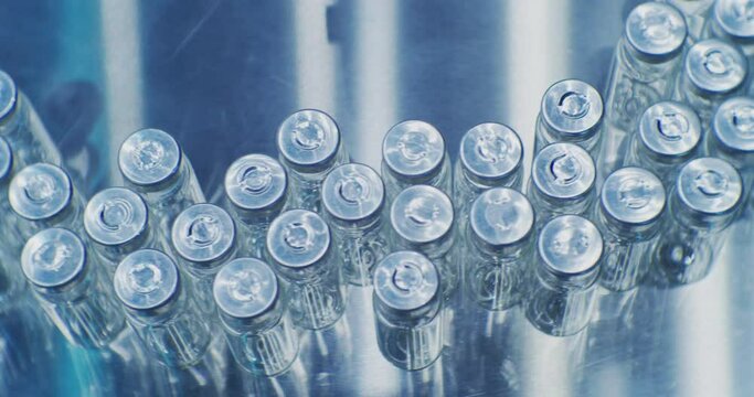 pharmaceutical industry.automatic production line machine conveyor with empty glass bottles at pharmacy processing factory. Medicine manufacturing and automated technology equipment.close-up.
