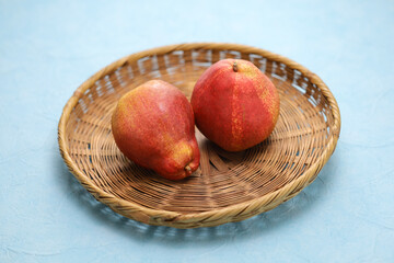 red comice pears on a bamboo tray
