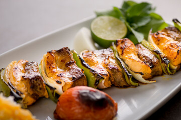 bakhteari tikka kabab with lime and salad served in dish isolated on grey background top view of arabic food