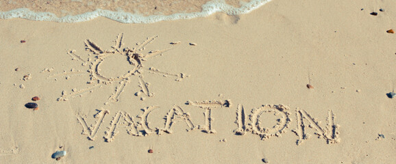 Word vacation and shape of sun written on sand at beach. Summer time. Place for text or inscription