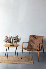 Gentle and beautiful Christmas arrangement of handmade flowers and candles in the interior. Christmas mood.